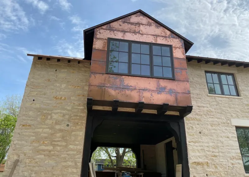 Copper metal panel facade on a stone building for Roof Repair in West Whiteland